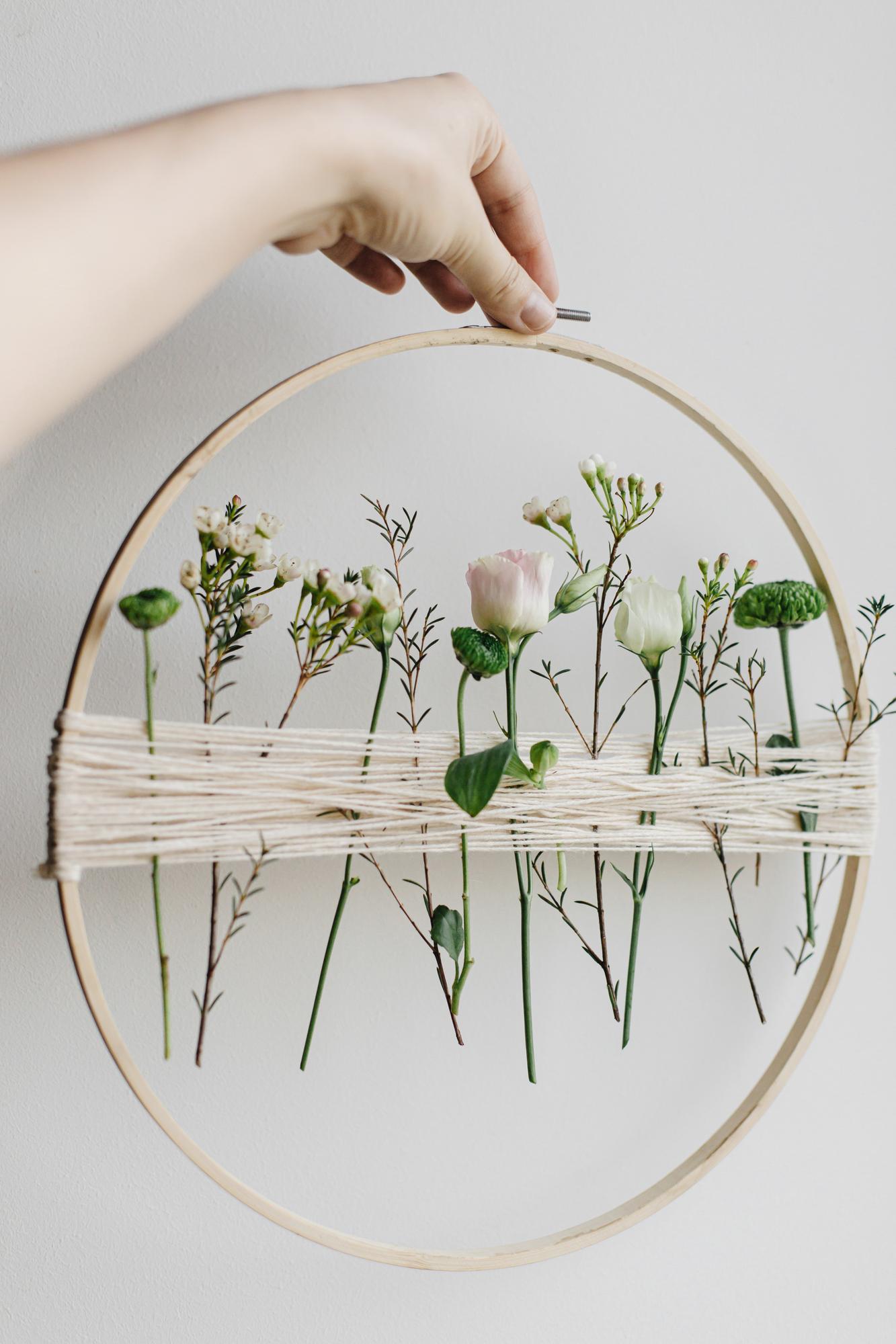 close-up of hand embroidery hoop with floral stitches