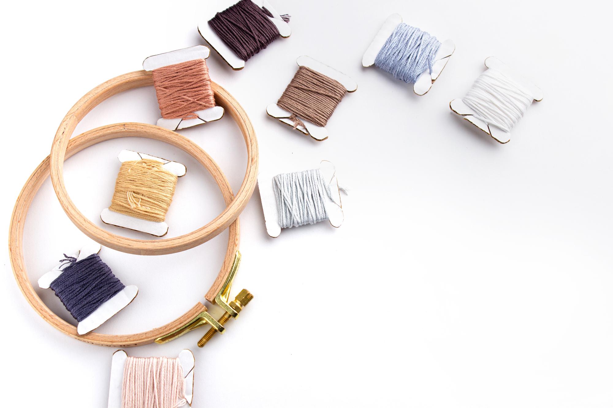 flatlay of finished embroidered samples and tools